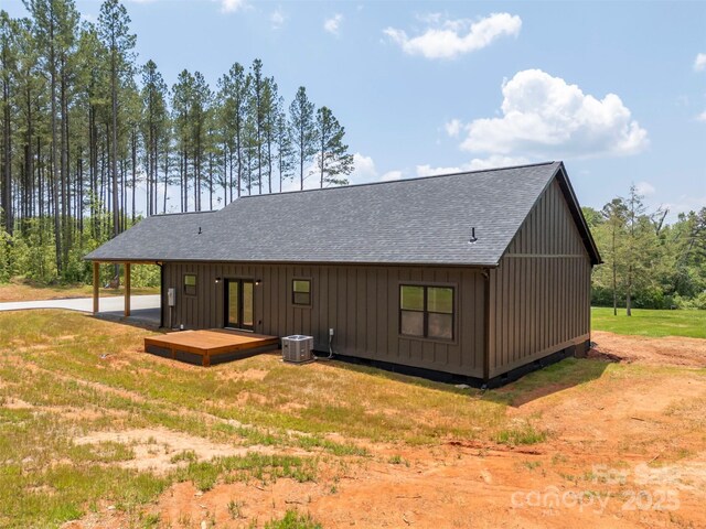 1872 Piney Mountain Church Rd, Bostic, NC 28018 - back of property featuring roof with shingles, french doors, board and batten siding, a lawn, and central air condition unit
