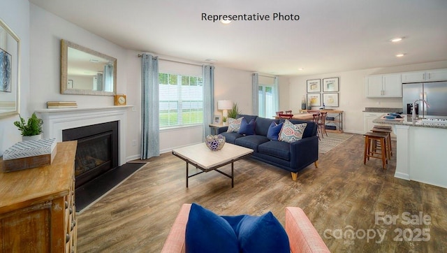 1342 37th Avenue Ln NE, Hickory, NC 28601 - living room featuring recessed lighting, dark wood-type flooring, a fireplace with flush hearth, and baseboards