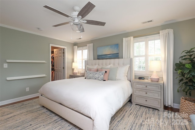 4126 Tyndale Ave, Charlotte, NC 28210 - bedroom featuring ornamental molding, light wood finished floors, a spacious closet, a ceiling fan, and a closet