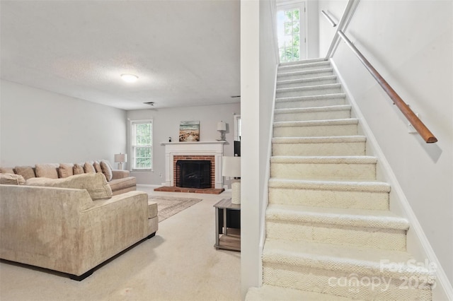 2308 Blair House Ct, Charlotte, NC 28270 - staircase with a brick fireplace, carpet, and a textured ceiling