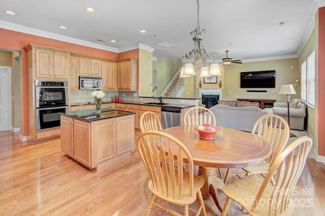 604 Palmerston Ln, Waxhaw, NC 28173 - dining area featuring light wood-style flooring, a fireplace, recessed lighting, ornamental molding, and ceiling fan