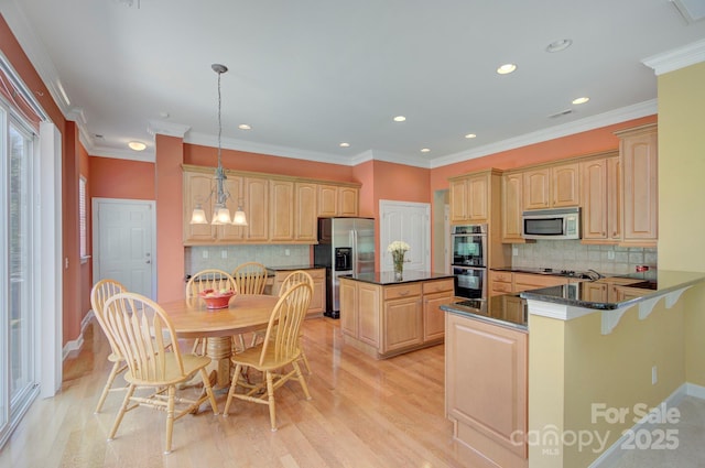 604 Palmerston Ln, Waxhaw, NC 28173 - kitchen with stainless steel appliances, tasteful backsplash, recessed lighting, light wood-style floors, and a center island