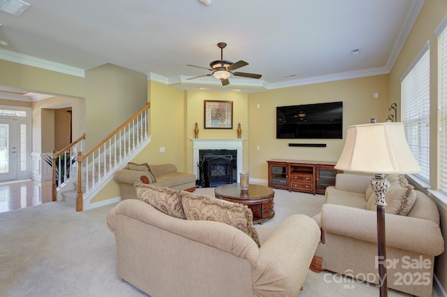 604 Palmerston Ln, Waxhaw, NC 28173 - carpeted living room featuring crown molding, stairway, a fireplace, and a ceiling fan