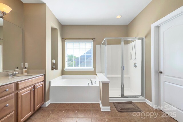 604 Palmerston Ln, Waxhaw, NC 28173 - bathroom featuring a stall shower, vanity, a garden tub, and tile patterned flooring
