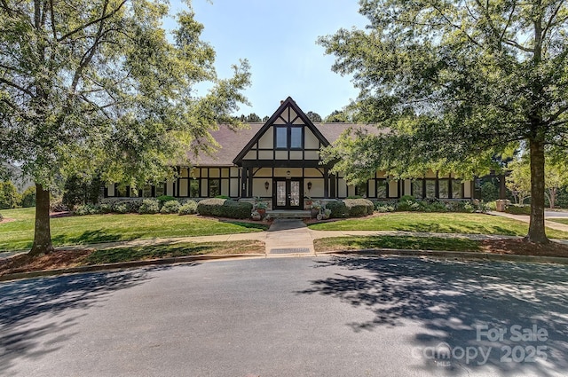 604 Palmerston Ln, Waxhaw, NC 28173 - tudor-style house with french doors, stucco siding, and a front lawn