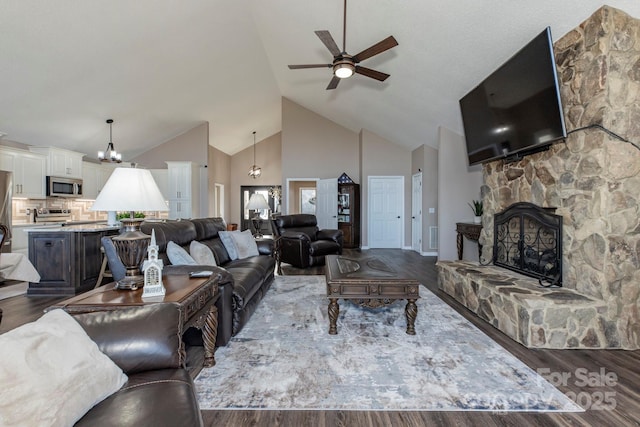 4933 NC Highway 268 W, Wilkesboro, NC 28697 - living area with ceiling fan, high vaulted ceiling, dark wood-type flooring, a fireplace, and a chandelier