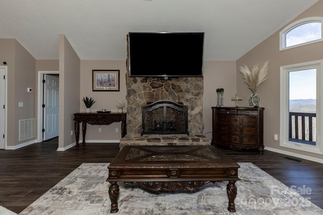 4933 NC Highway 268 W, Wilkesboro, NC 28697 - living room with lofted ceiling, wood finished floors, a stone fireplace, and baseboards