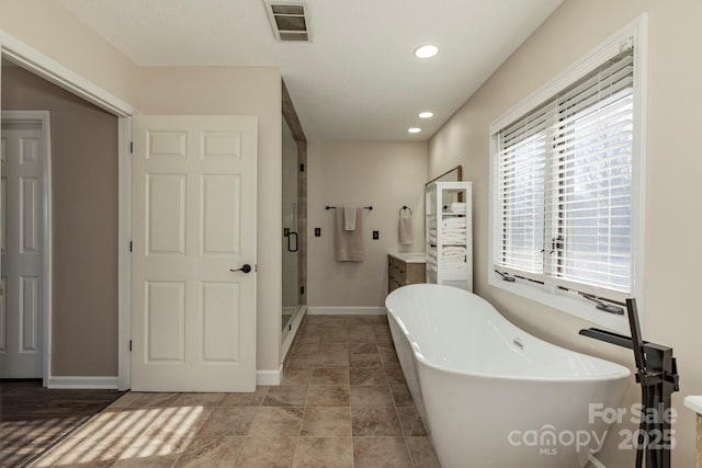 4933 NC Highway 268 W, Wilkesboro, NC 28697 - bathroom with a freestanding tub, a stall shower, recessed lighting, baseboards, and vanity