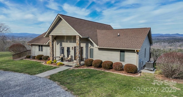 4933 NC Highway 268 W, Wilkesboro, NC 28697 - view of front of house featuring central AC unit, a front lawn, a mountain view, and a shingled roof