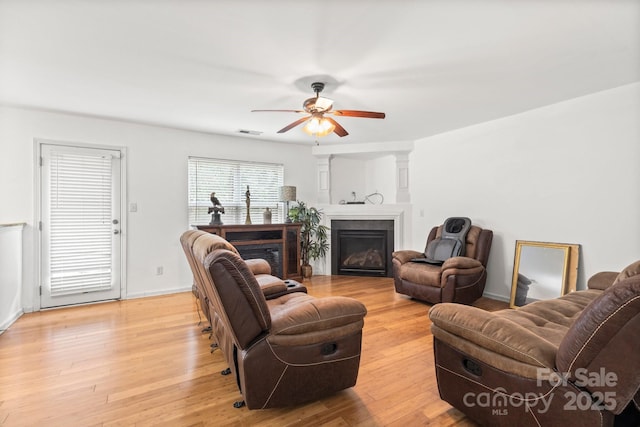 9236 Clifton Meadow Dr, Matthews, NC 28105 - living area with a ceiling fan, light wood finished floors, and a glass covered fireplace