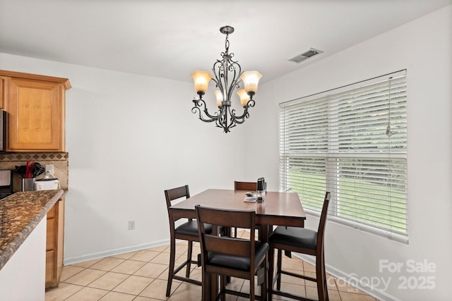 9236 Clifton Meadow Dr, Matthews, NC 28105 - dining space with plenty of natural light, a chandelier, and light tile patterned floors