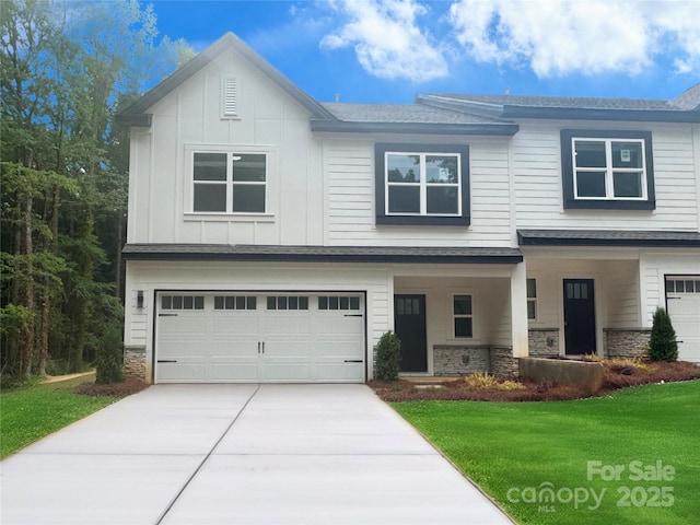 8303 Adrian Ct, Charlotte, NC 28270 - view of front of property with an attached garage, a front yard, stone siding, and concrete driveway