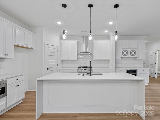 8303 Adrian Ct, Charlotte, NC 28270 - kitchen with wall chimney range hood, a sink, ornamental molding, tasteful backsplash, and white cabinetry