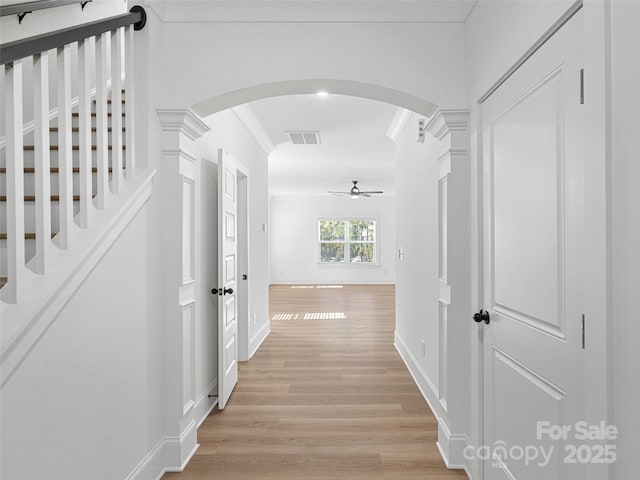 8303 Adrian Ct, Charlotte, NC 28270 - hall featuring arched walkways, light wood-style flooring, crown molding, and baseboards