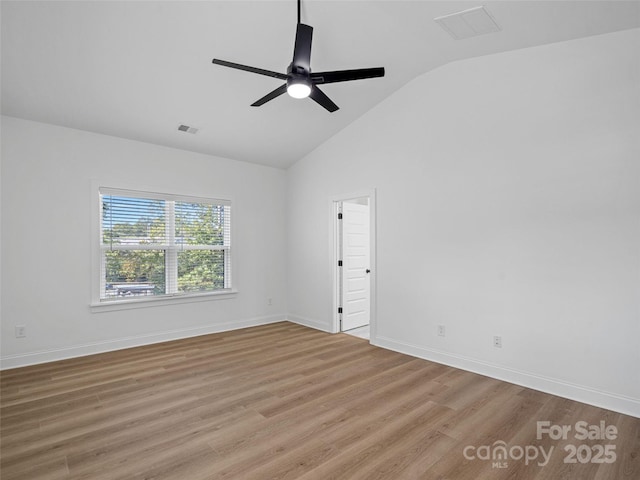 8303 Adrian Ct, Charlotte, NC 28270 - empty room with vaulted ceiling, wood finished floors, a ceiling fan, and baseboards