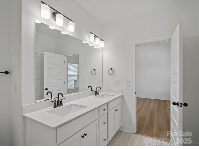 8303 Adrian Ct, Charlotte, NC 28270 - full bath featuring wood finished floors, double vanity, and baseboards