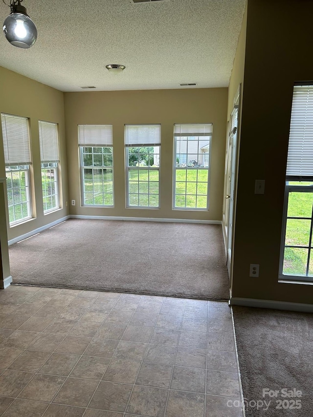 8125 Weeping Fig Ln, Charlotte, NC 28215 - carpeted empty room with baseboards and a textured ceiling