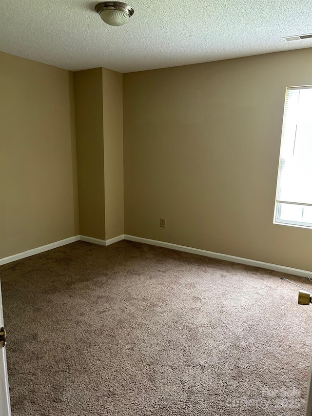 8125 Weeping Fig Ln, Charlotte, NC 28215 - carpeted empty room featuring a textured ceiling
