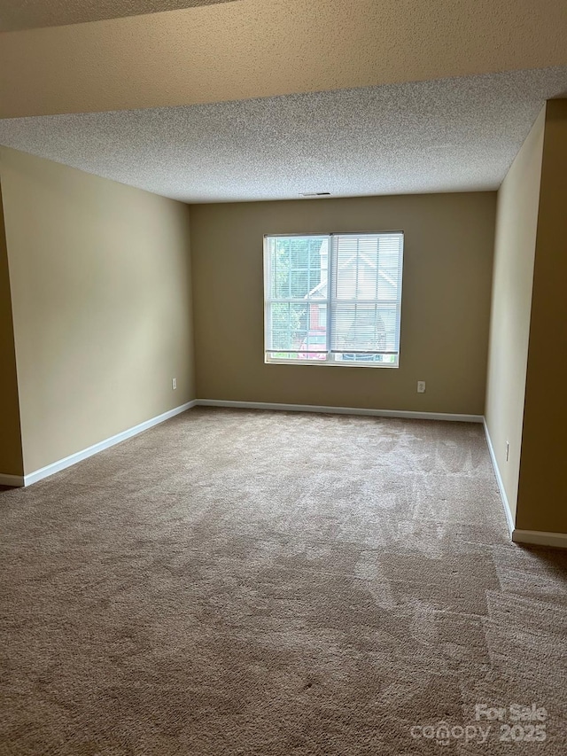 8125 Weeping Fig Ln, Charlotte, NC 28215 - spare room with carpet flooring and a textured ceiling