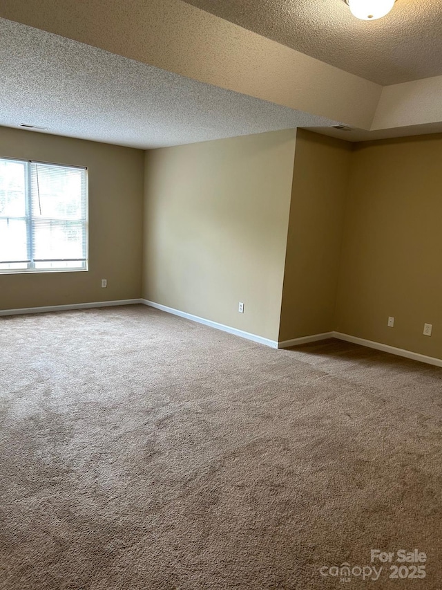 8125 Weeping Fig Ln, Charlotte, NC 28215 - carpeted empty room featuring a textured ceiling and baseboards