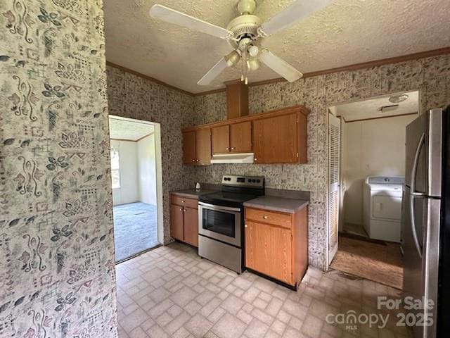 5587 Doe Ct, Morganton, NC 28655 - kitchen featuring appliances with stainless steel finishes, under cabinet range hood, washer / clothes dryer, ornamental molding, and wallpapered walls