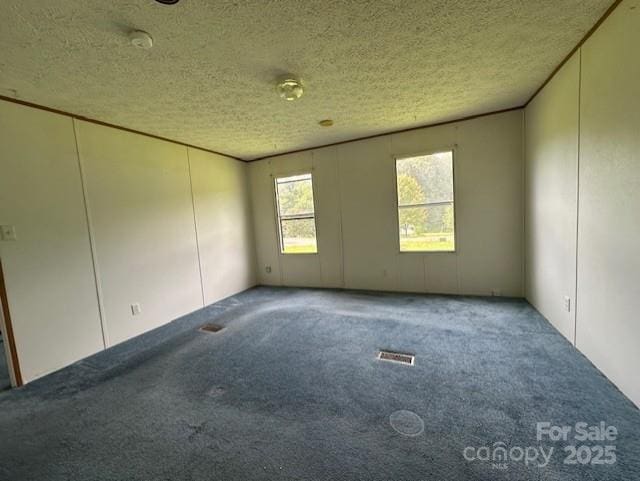 5587 Doe Ct, Morganton, NC 28655 - empty room featuring carpet floors and a textured ceiling