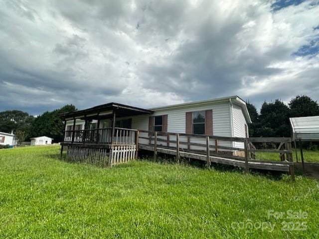 5587 Doe Ct, Morganton, NC 28655 - back of house with a wooden deck and a lawn