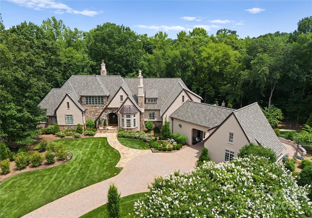 8500 Longview Club Dr, Waxhaw, NC 28173 - english style home with stone siding, stucco siding, a chimney, and a front yard
