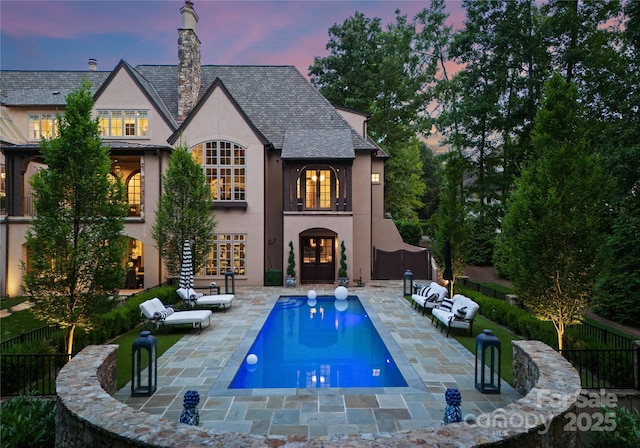 8500 Longview Club Dr, Waxhaw, NC 28173 - back of property featuring stucco siding, a patio, and a chimney