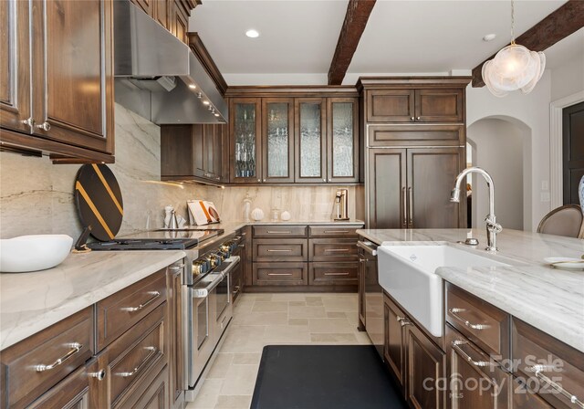 8500 Longview Club Dr, Waxhaw, NC 28173 - kitchen with ventilation hood, stainless steel appliances, backsplash, arched walkways, and beam ceiling