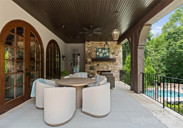 8500 Longview Club Dr, Waxhaw, NC 28173 - view of patio / terrace with an outdoor stone fireplace, a ceiling fan, and french doors