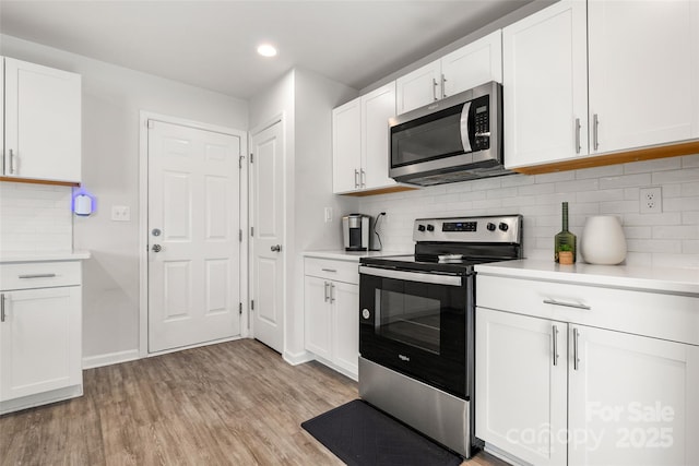 4209 Grier St, Gastonia, NC 28056 - kitchen featuring appliances with stainless steel finishes, light countertops, light wood-style floors, white cabinets, and recessed lighting
