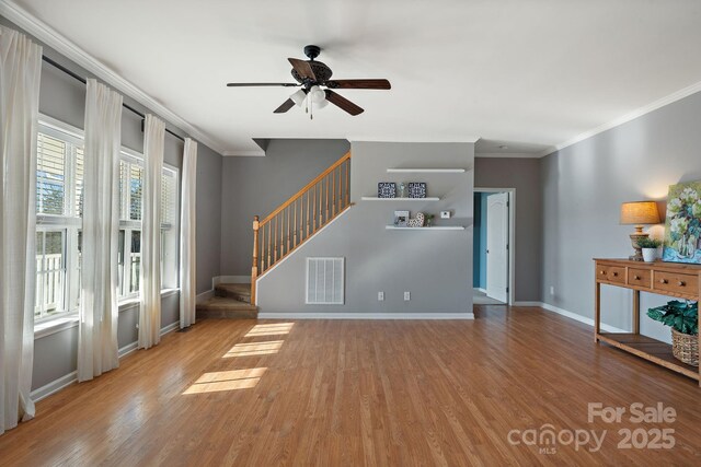 1285 Waitman Rd, Lexington, NC 27295 - unfurnished living room with crown molding, a ceiling fan, stairs, wood finished floors, and baseboards