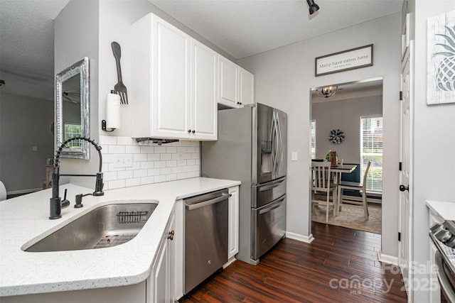 108 Shade Tree Cir, Fort Mill, SC 29715 - kitchen featuring appliances with stainless steel finishes, dark wood finished floors, white cabinetry, backsplash, and light stone counters