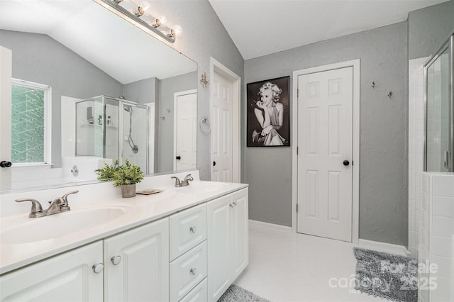 108 Shade Tree Cir, Fort Mill, SC 29715 - full bathroom featuring a shower stall, double vanity, a textured wall, and lofted ceiling