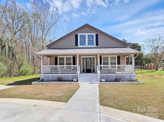 12300 Caldwell Rd, Charlotte, NC 28213 - view of front of home featuring covered porch, a front yard, and a metal roof