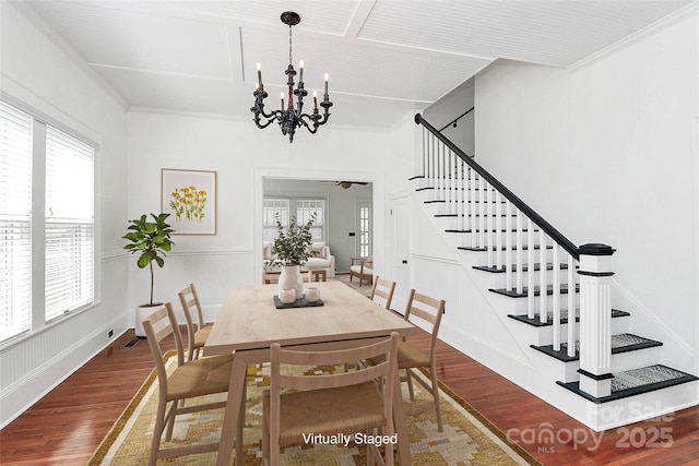 12300 Caldwell Rd, Charlotte, NC 28213 - dining room with stairs, wood finished floors, a chandelier, a ceiling fan, and crown molding