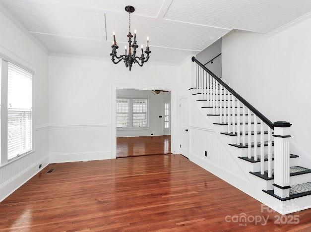 12300 Caldwell Rd, Charlotte, NC 28213 - stairway featuring a chandelier, healthy amount of natural light, and wood finished floors
