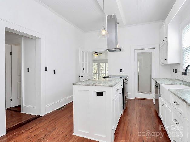 12300 Caldwell Rd, Charlotte, NC 28213 - kitchen featuring stainless steel appliances, wall chimney exhaust hood, white cabinets, light stone counters, and dark wood-type flooring