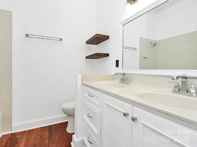 12300 Caldwell Rd, Charlotte, NC 28213 - full bathroom with double vanity, wood finished floors, and a shower