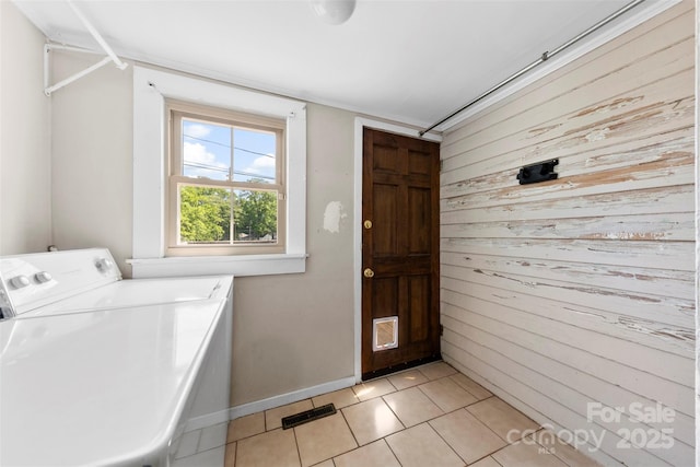 1008 Valley St, Kannapolis, NC 28081 - laundry room with wooden walls, washing machine and clothes dryer, and light tile patterned floors