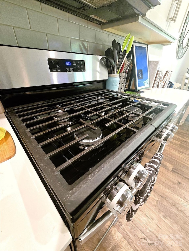 3816 Rosewood Dr, Mount Holly, NC 28120 - kitchen view of gas stove and wood finished floors