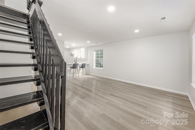 3941 Briarhill Dr, Charlotte, NC 28215 - staircase featuring wood finished floors, baseboards, and recessed lighting