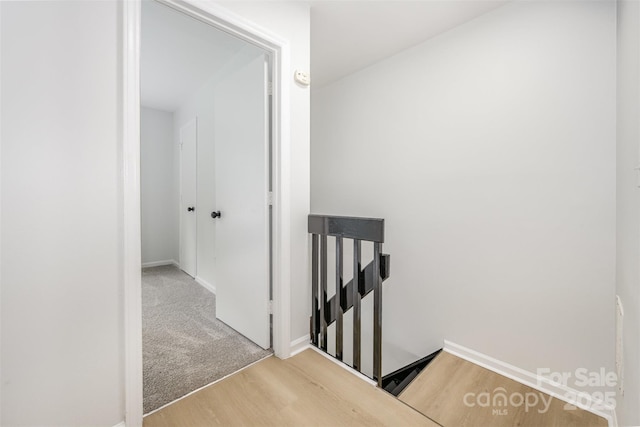3941 Briarhill Dr, Charlotte, NC 28215 - hall featuring an upstairs landing, wood finished floors, and baseboards