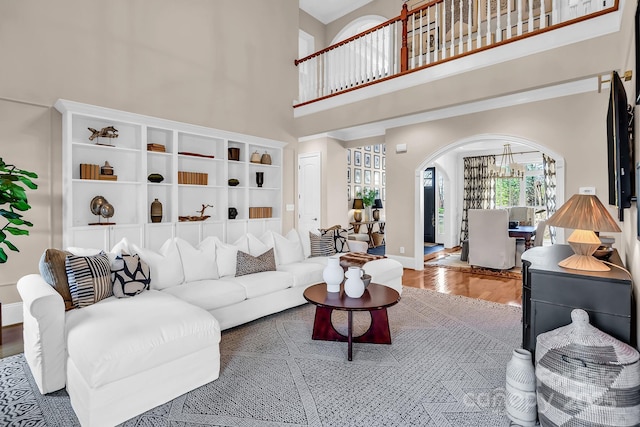 394 Stonecliff Ln, Clover, SC 29710 - living room featuring arched walkways, wood finished floors, and a high ceiling