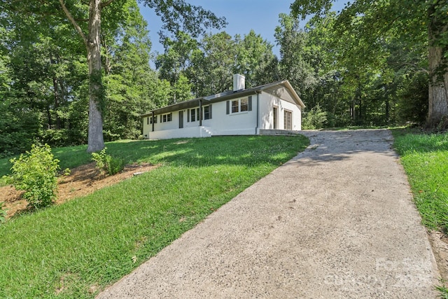 848 Ike Lynch Rd, Dallas, NC 28034 - ranch-style house featuring asphalt driveway, a front yard, a chimney, a garage, and stucco siding