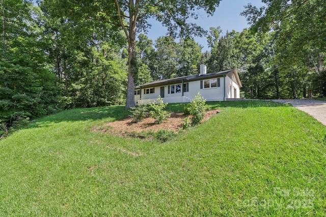 848 Ike Lynch Rd, Dallas, NC 28034 - ranch-style house with a front yard, a chimney, stucco siding, and driveway