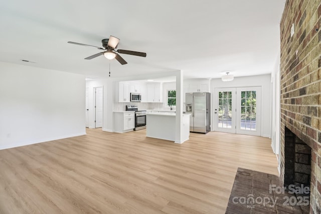 848 Ike Lynch Rd, Dallas, NC 28034 - unfurnished living room with a fireplace, a ceiling fan, and light wood finished floors