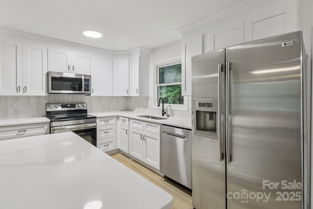 848 Ike Lynch Rd, Dallas, NC 28034 - kitchen with stainless steel appliances, light wood-style floors, white cabinets, and light countertops