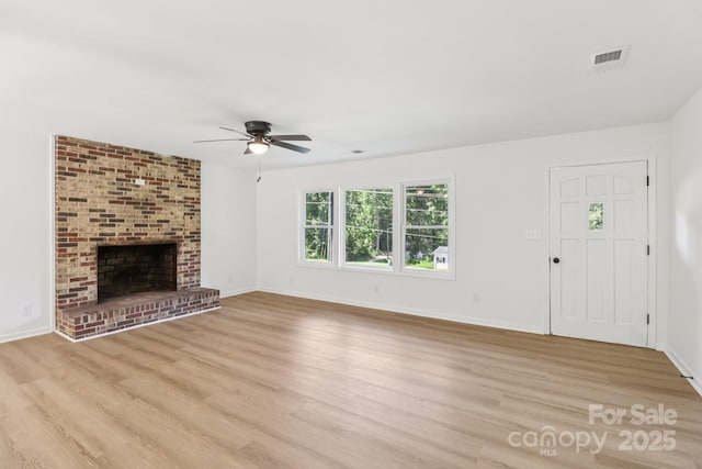 848 Ike Lynch Rd, Dallas, NC 28034 - unfurnished living room with ceiling fan, light wood-type flooring, and a brick fireplace